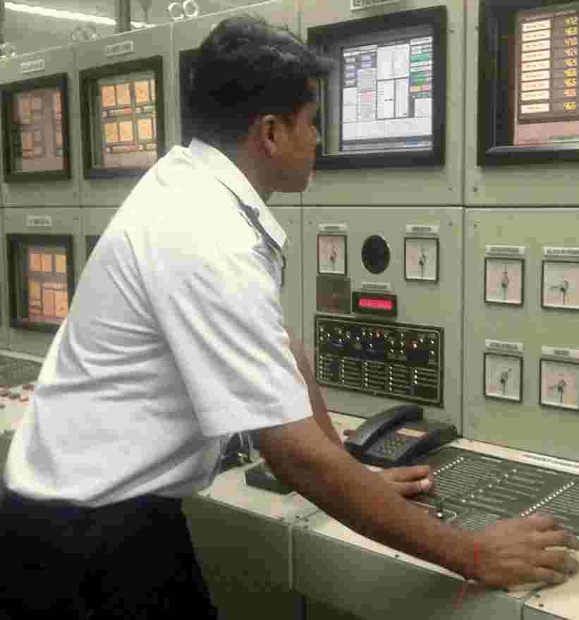 electro technical officer monitoring machines in engine room